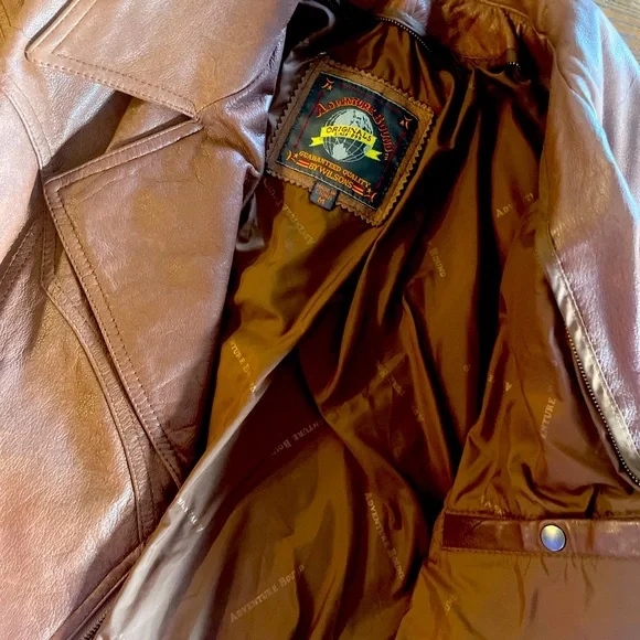 Vintage Brown leather moto jacket with zipper closure and belt detail.